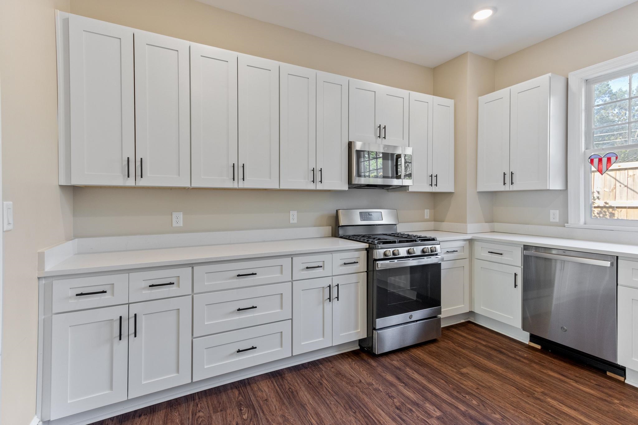 4775 Macon Road Memphis, TN 38122 - Photo 16 of 31 a kitchen with stainless steel appliances granite countertop a stove a sink and white cabinets