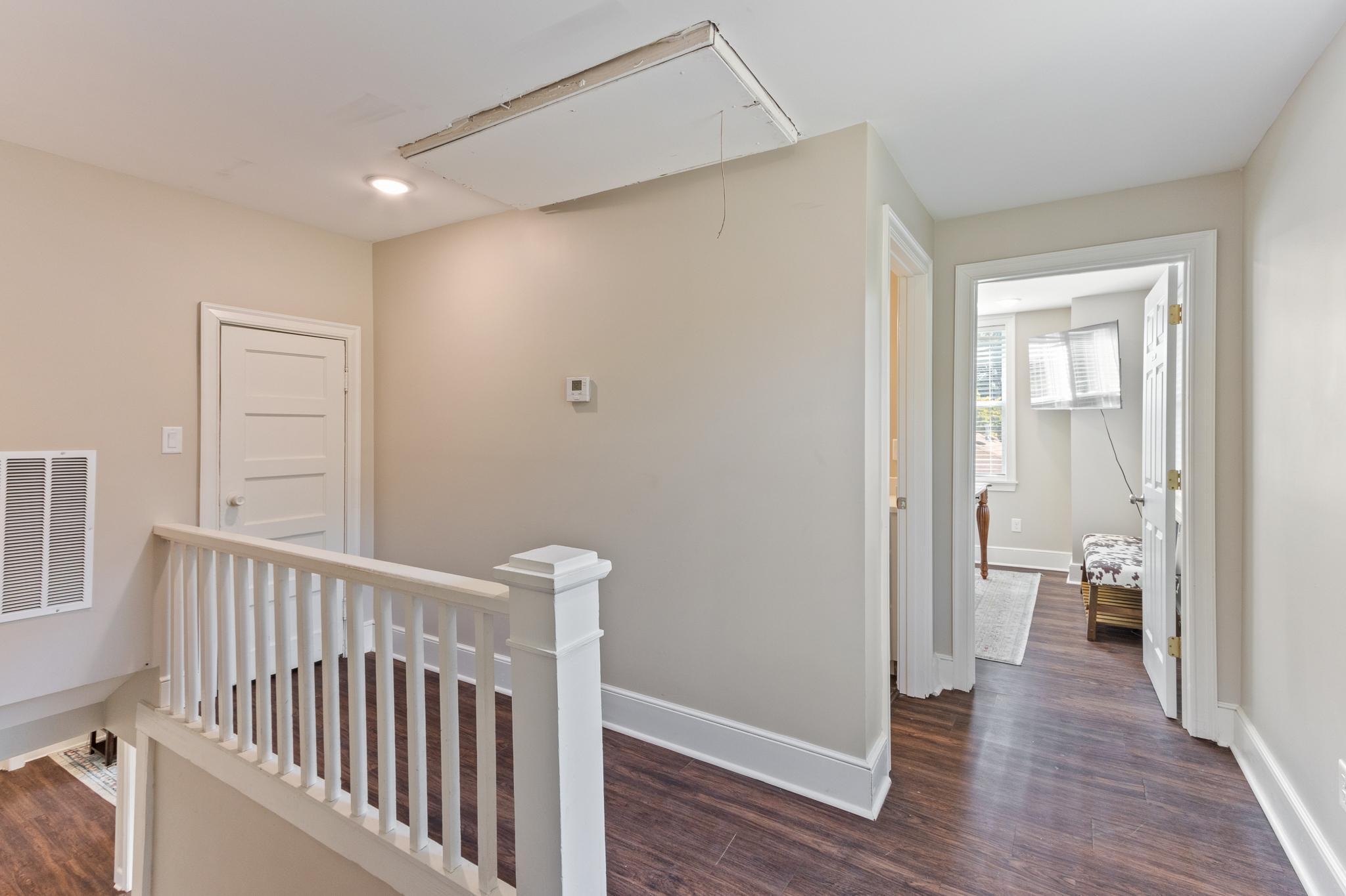 4775 Macon Road Memphis, TN 38122 - Photo 21 of 31 a view of a hallway with wooden floor and a bathroom
