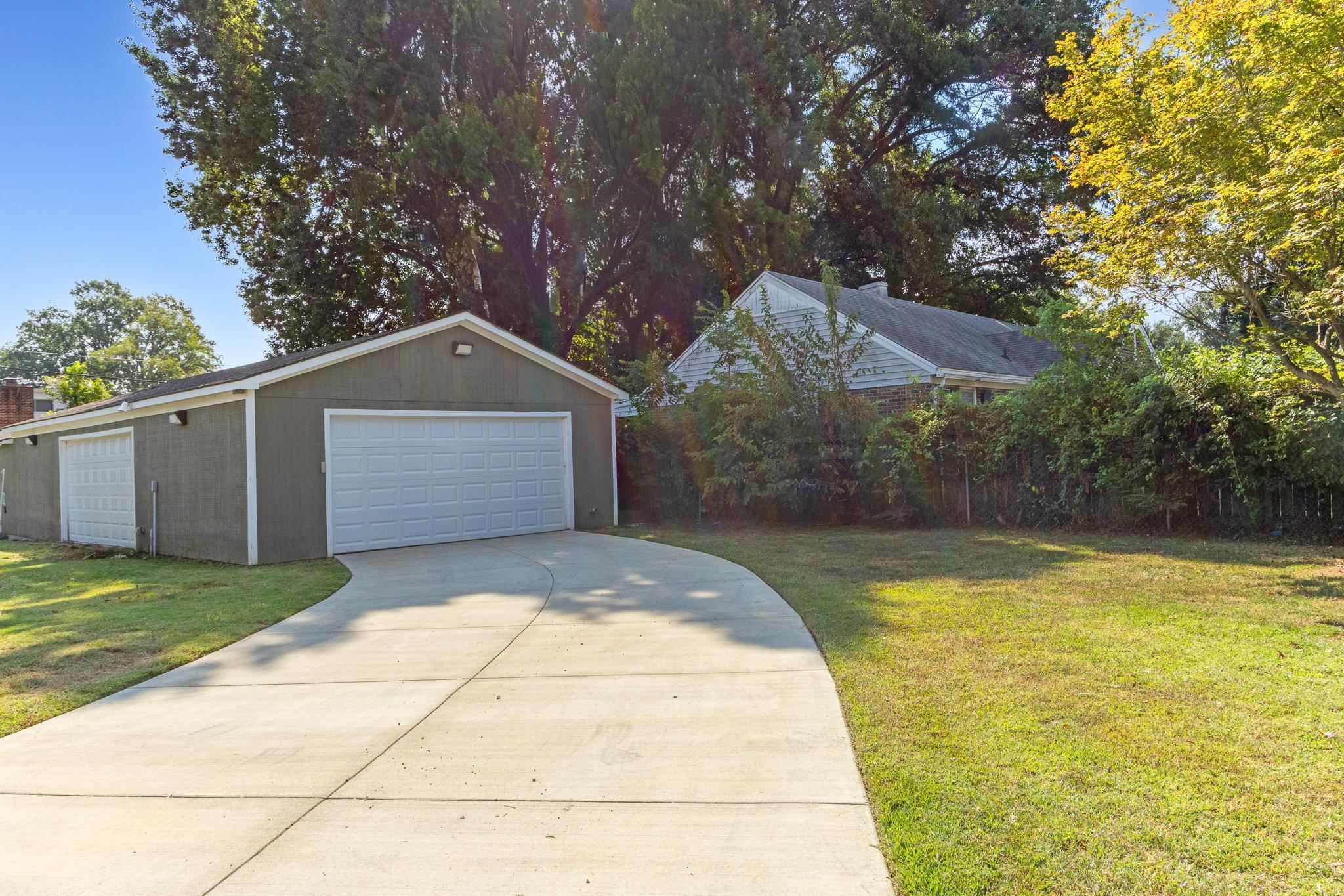 4775 Macon Road Memphis, TN 38122 - Photo 28 of 31 a front view of a house with a yard and garage