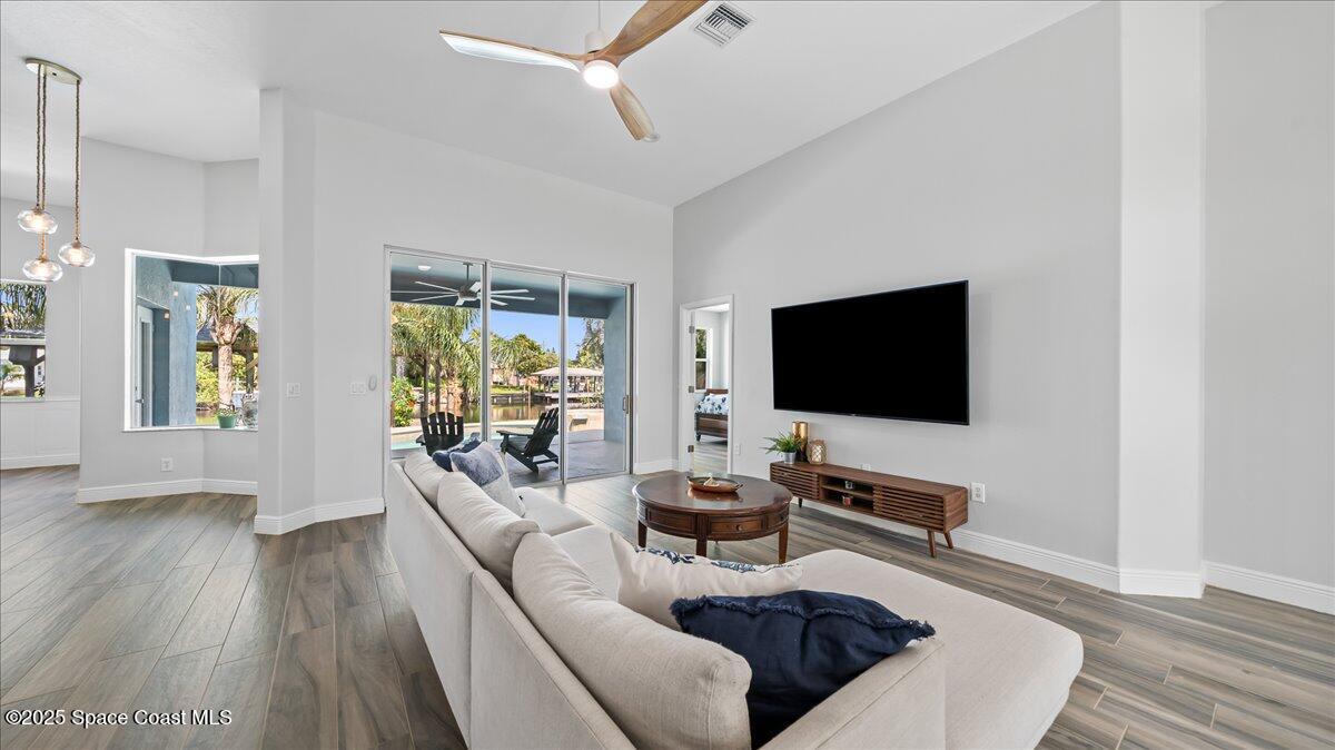 121 Boca Ciega Road Cocoa Beach, FL 32931 - Photo 11 of 50 a living room with furniture and a flat screen tv