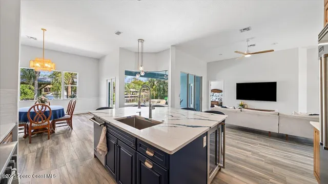 a kitchen with a stove and a wooden floor