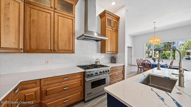a kitchen with stainless steel appliances a stove a sink and cabinets