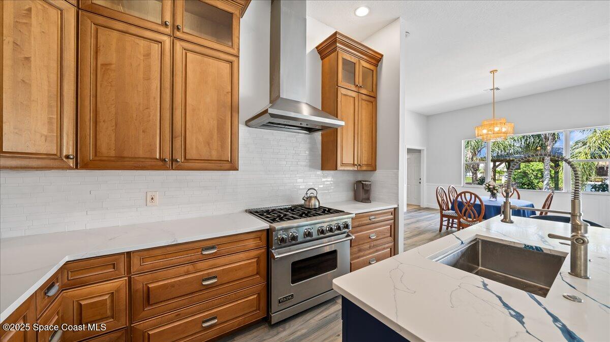 121 Boca Ciega Road Cocoa Beach, FL 32931 - Photo 16 of 50 a kitchen with stainless steel appliances a stove a sink and cabinets