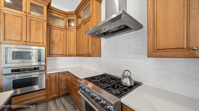 a kitchen with stainless steel appliances granite countertop a stove and a microwave