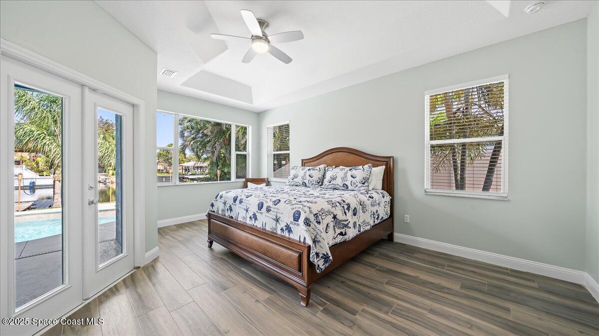 121 Boca Ciega Road Cocoa Beach, FL 32931 - Photo 22 of 50 a bedroom with a large bed and a window