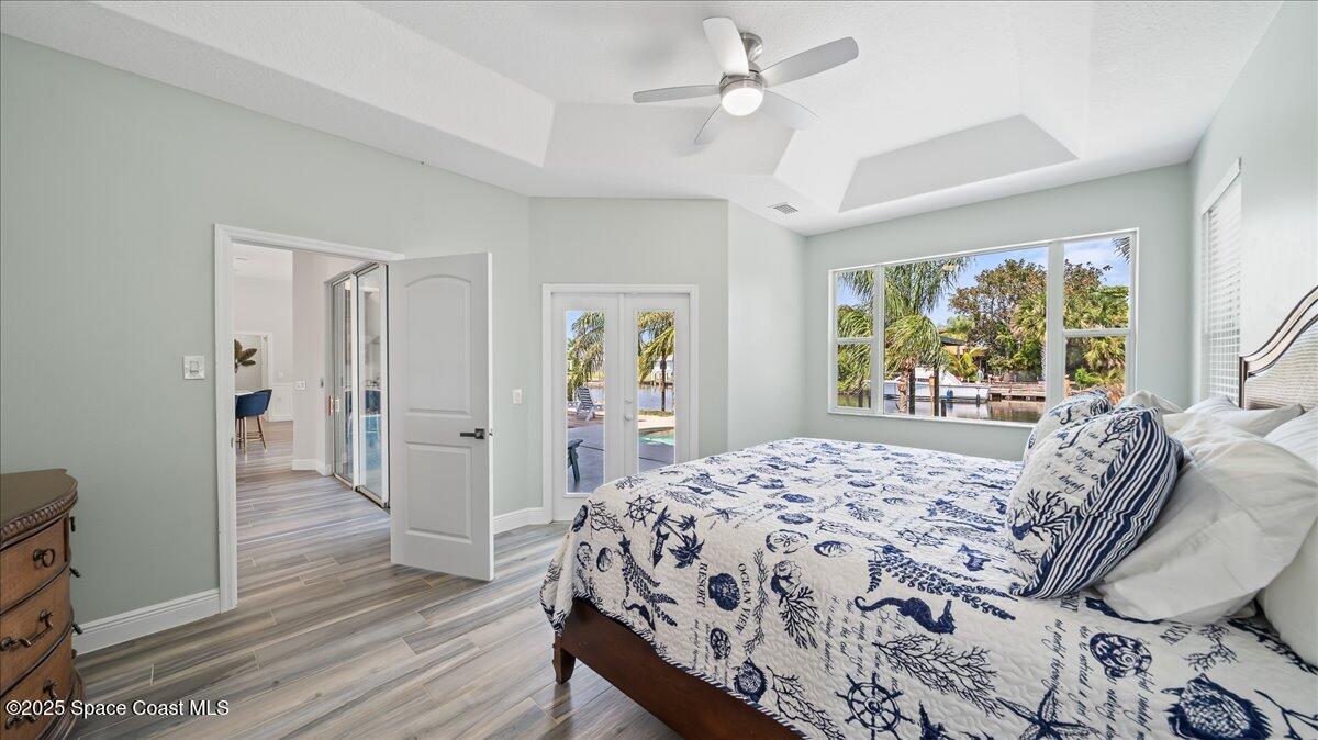 121 Boca Ciega Road Cocoa Beach, FL 32931 - Photo 23 of 50 a bedroom with a bed and a large window with the outer view