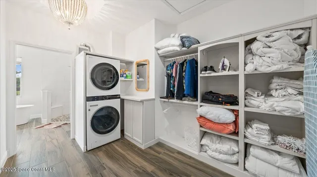 a view of a storage and utility room with washer and dryer