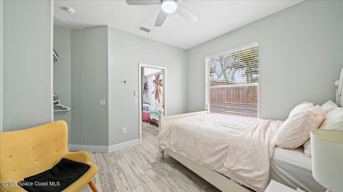 121 Boca Ciega Road Cocoa Beach, FL 32931 - Photo 28 of 50 a bedroom with a bed and a couch