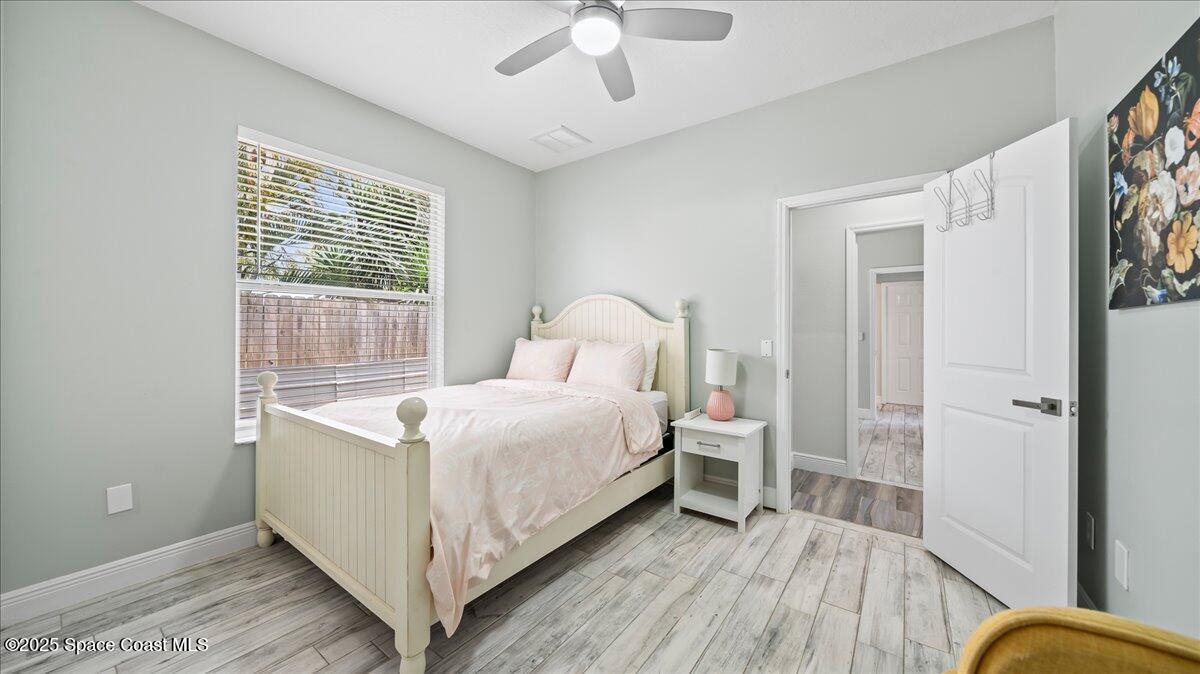 121 Boca Ciega Road Cocoa Beach, FL 32931 - Photo 29 of 50 a bedroom with a bed and a window