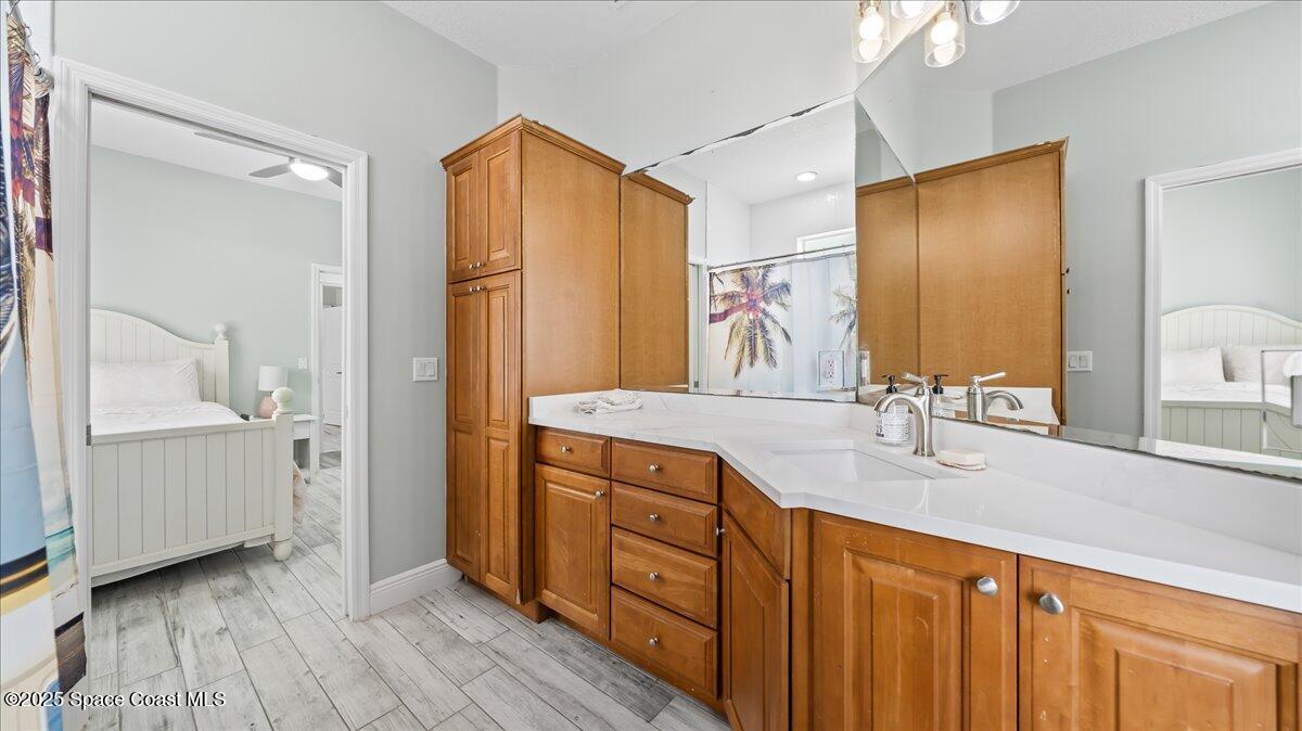 121 Boca Ciega Road Cocoa Beach, FL 32931 - Photo 30 of 50 a spacious bathroom with a double vanity sink and a mirror