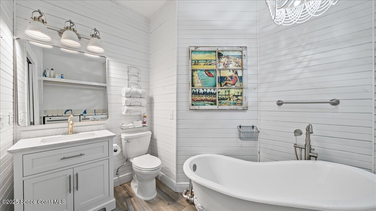 121 Boca Ciega Road Cocoa Beach, FL 32931 - Photo 33 of 50 a bathroom with a toilet sink and mirror