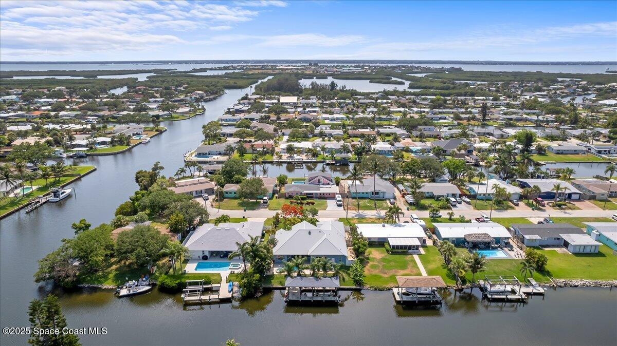 121 Boca Ciega Road Cocoa Beach, FL 32931 - Photo 48 of 50 an aerial view of a city with lots of residential buildings ocean and mountain view in back