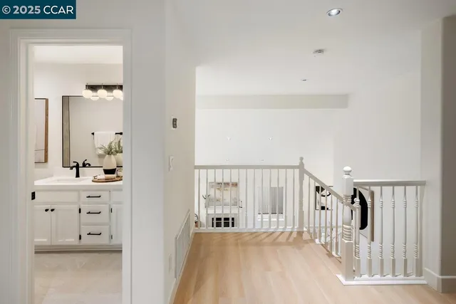 a view of a bedroom with wooden floor