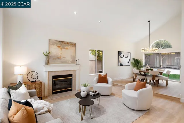 a living room with furniture a fireplace and a window