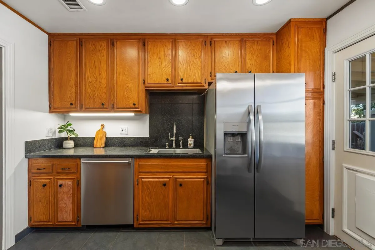2707 Sweetwater Road Spring Valley, CA 91977 - Photo 16 of 30 a kitchen with stainless steel appliances granite countertop a refrigerator and a sink