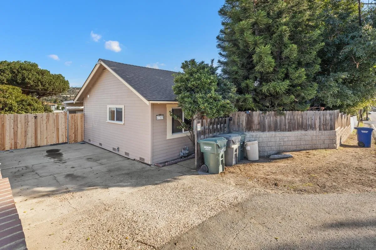 2707 Sweetwater Road Spring Valley, CA 91977 - Photo 25 of 30 a view of a backyard with a tree and wooden fence