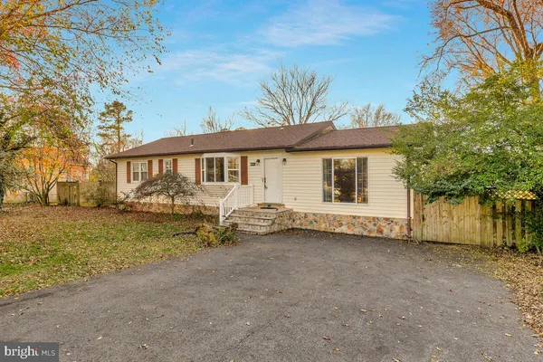 a view of a house with a yard and tree