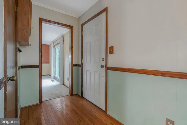 a view of a hallway with wooden floor