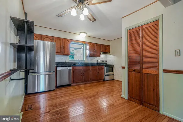 a kitchen with stainless steel appliances a refrigerator and a stove top oven