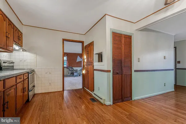 a kitchen with a wooden floor and a stove top oven