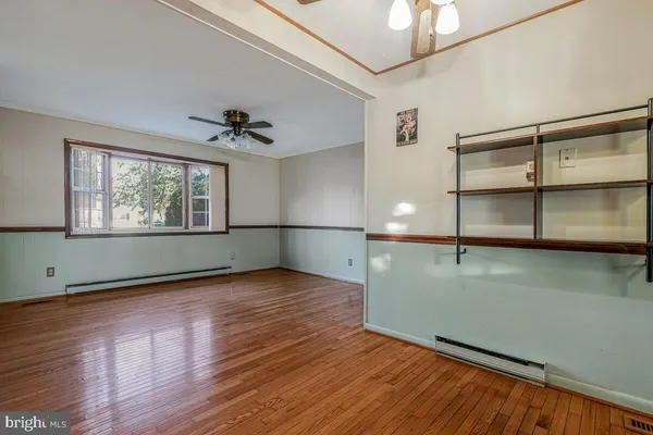 wooden floor in an empty room with a window