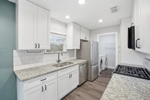 a kitchen with a sink stove and refrigerator