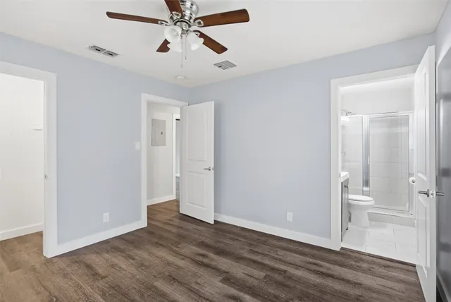 a view of an empty room and wooden floor
