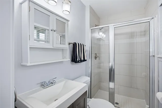 a bathroom with a sink toilet and shower