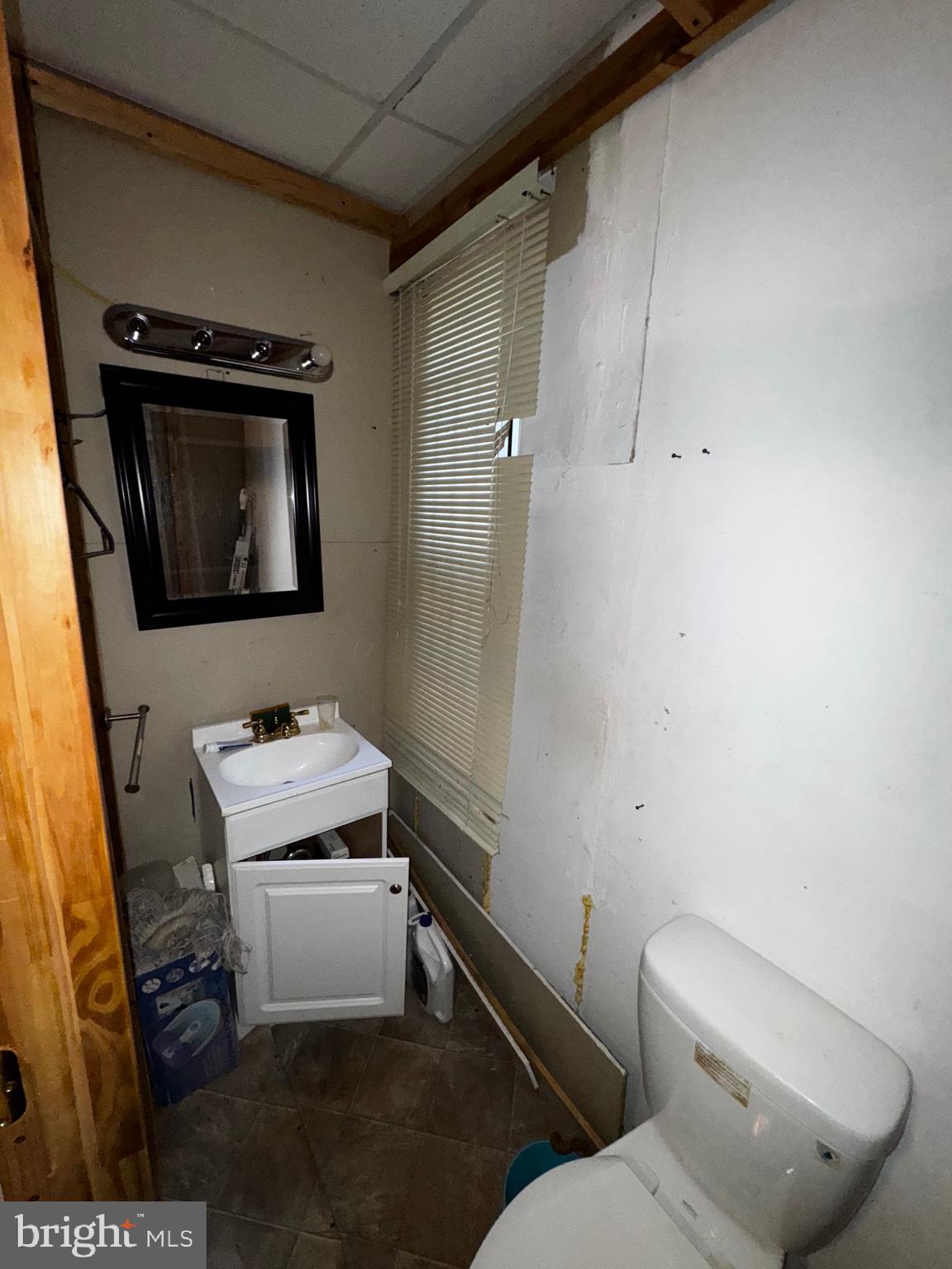 1661 North 56th Street Philadelphia, PA 19131 - Photo 8 of 30 a bathroom with a toilet sink and mirror
