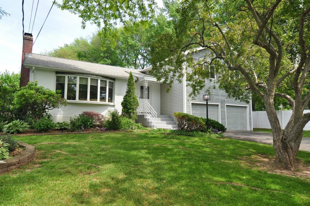 a front view of house with yard and green space
