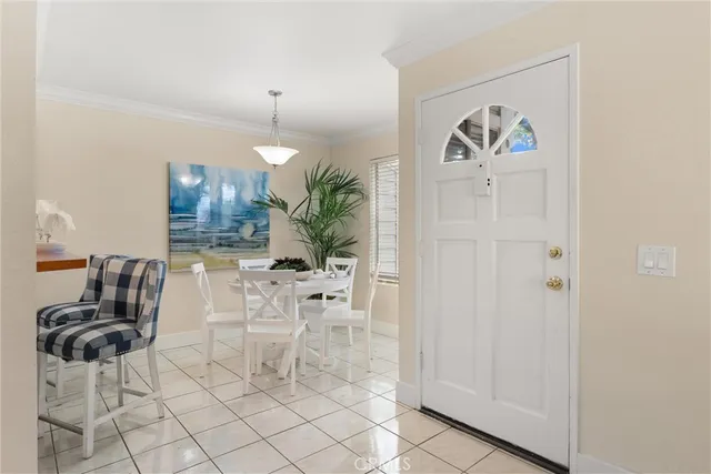 a bedroom with a large bed and potted plant