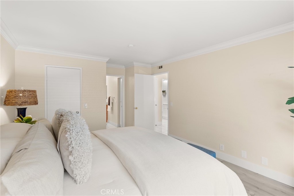 22232 South Vermont Avenue, Unit 102B Torrance, CA 90502 - Photo 14 of 26 a bedroom with a bed and a lamp