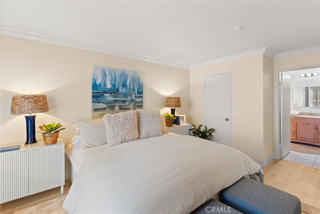 22232 South Vermont Avenue, Unit 102B Torrance, CA 90502 - Photo 15 of 26 a bedroom with a bed and wooden floor