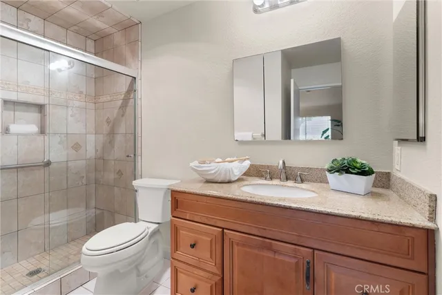 a bedroom with a bed and a potted plant