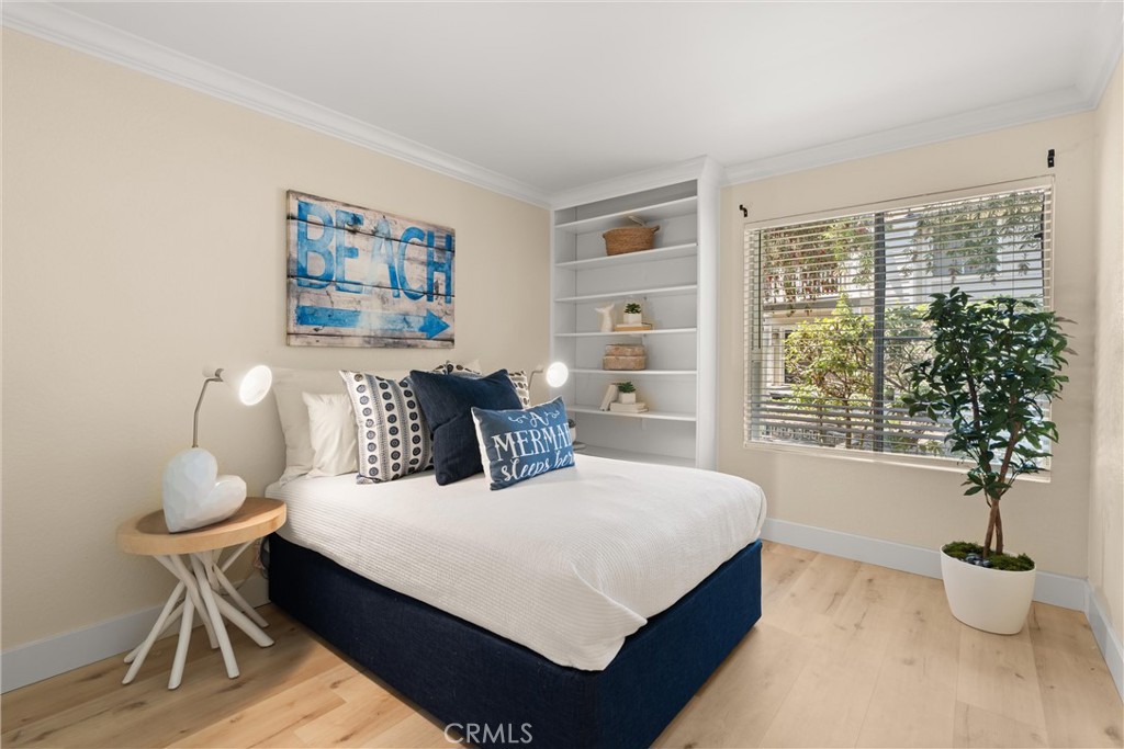 22232 South Vermont Avenue, Unit 102B Torrance, CA 90502 - Photo 18 of 26 a bedroom with a bed and a potted plant