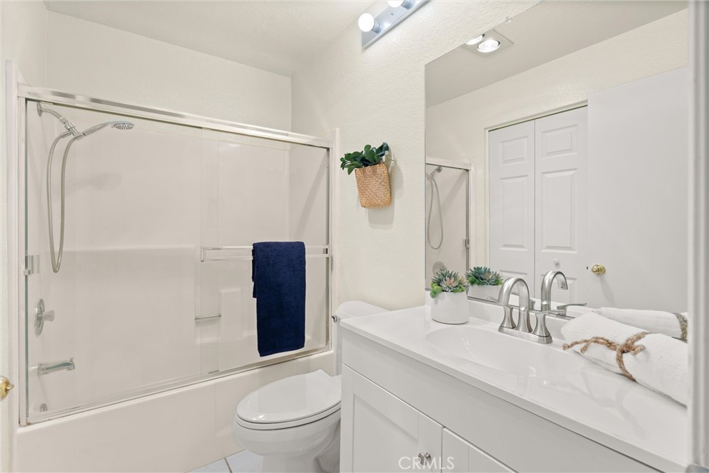 22232 South Vermont Avenue, Unit 102B Torrance, CA 90502 - Photo 19 of 26 a bathroom with a granite countertop sink a toilet and shower