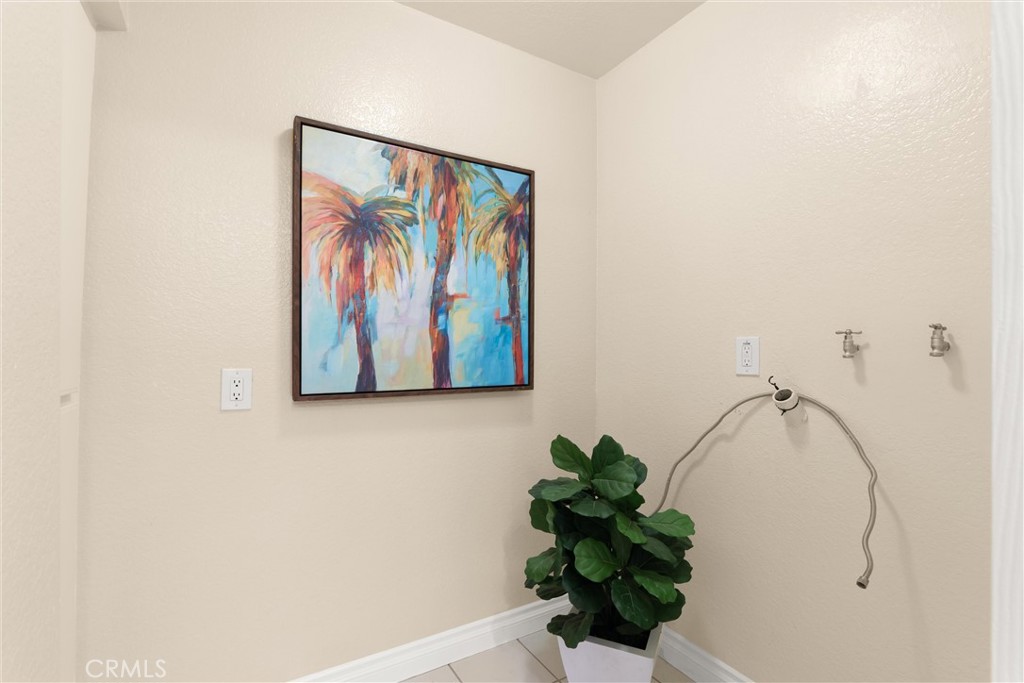 22232 South Vermont Avenue, Unit 102B Torrance, CA 90502 - Photo 20 of 26 a picture of wall with a vase and flowers on it