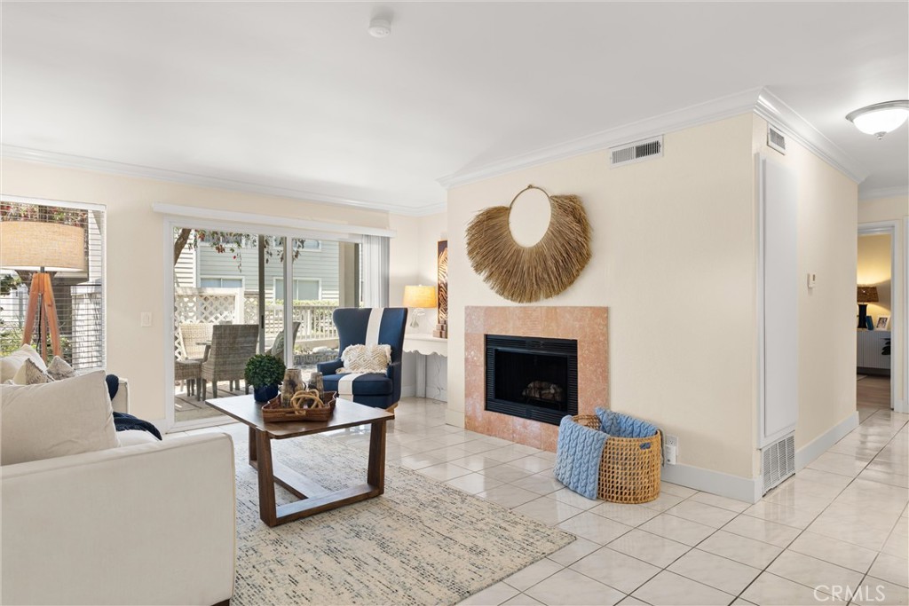 22232 South Vermont Avenue, Unit 102B Torrance, CA 90502 - Photo 3 of 26 a living room with furniture and a fireplace