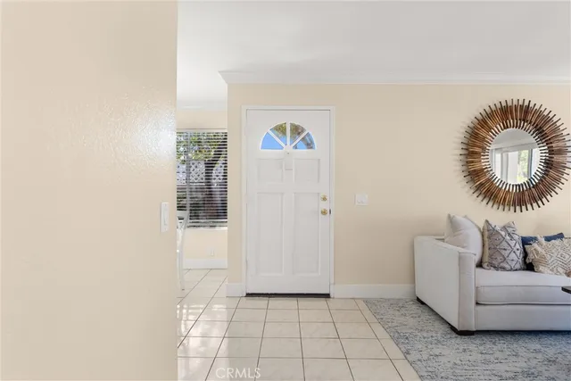 a hallway with a couch and a potted plant