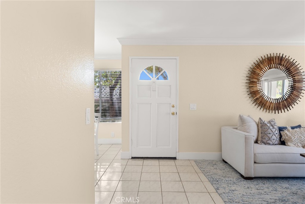 22232 South Vermont Avenue, Unit 102B Torrance, CA 90502 - Photo 5 of 26 a hallway with a couch and a potted plant