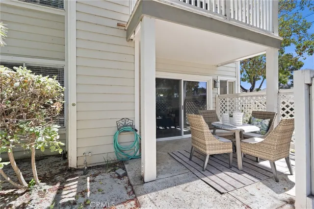 a view of a patio with table and chairs and potted plants