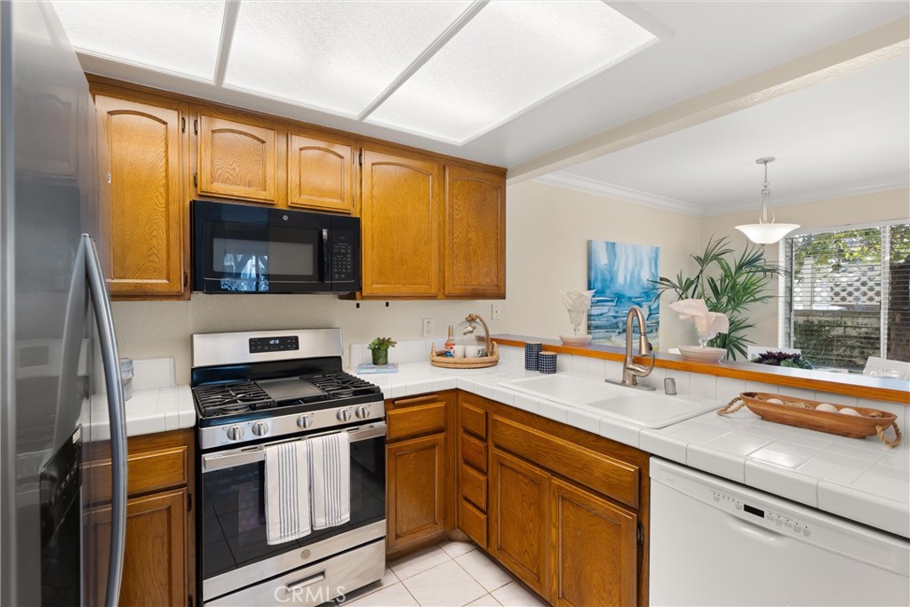 22232 South Vermont Avenue, Unit 102B Torrance, CA 90502 - Photo 8 of 26 a kitchen with a sink stove and microwave