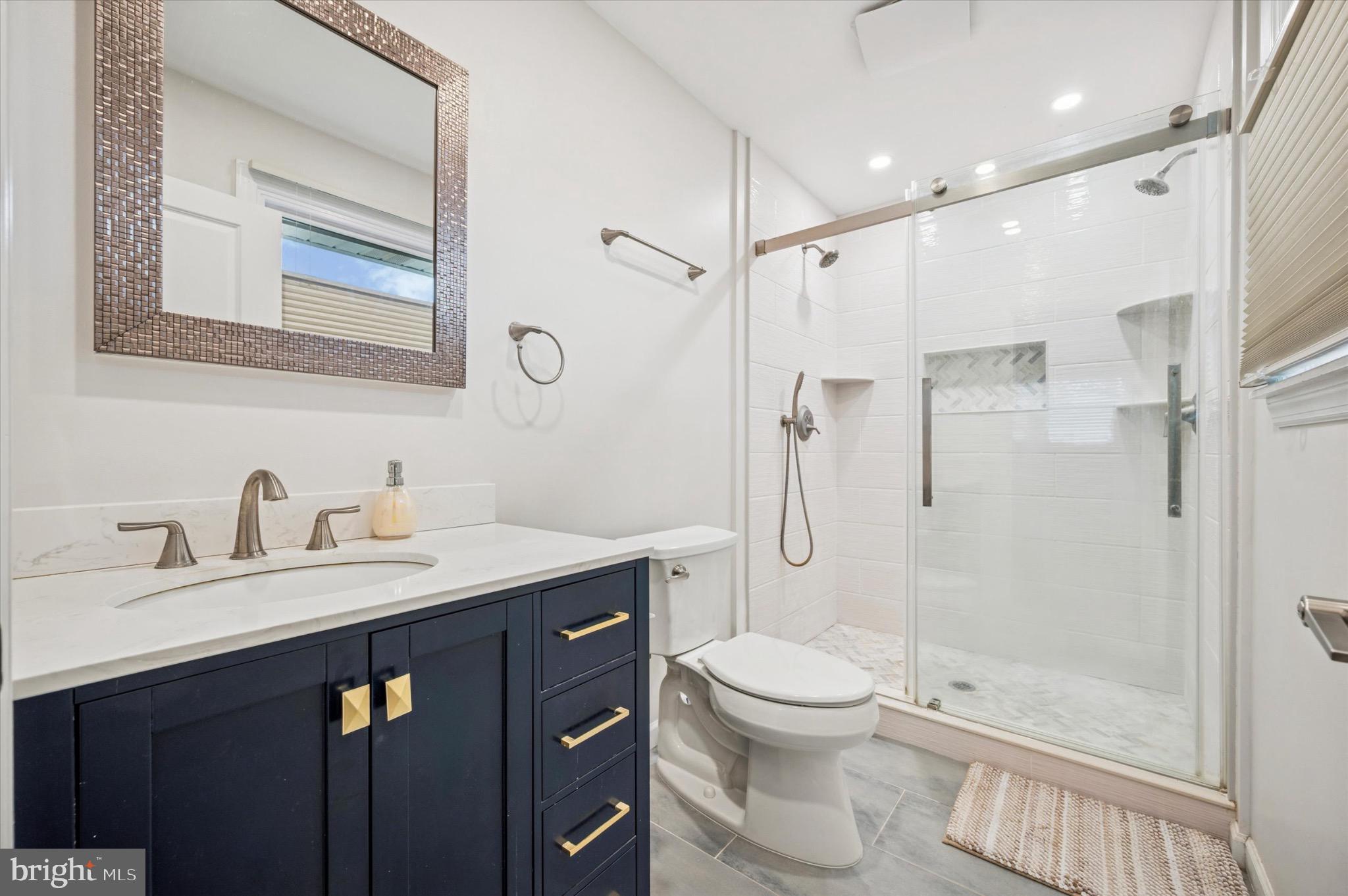 7410 Richards Road Elkins Park, PA 19027 - Photo 12 of 22 a bathroom with a granite countertop sink toilet a mirror a shower and vanity