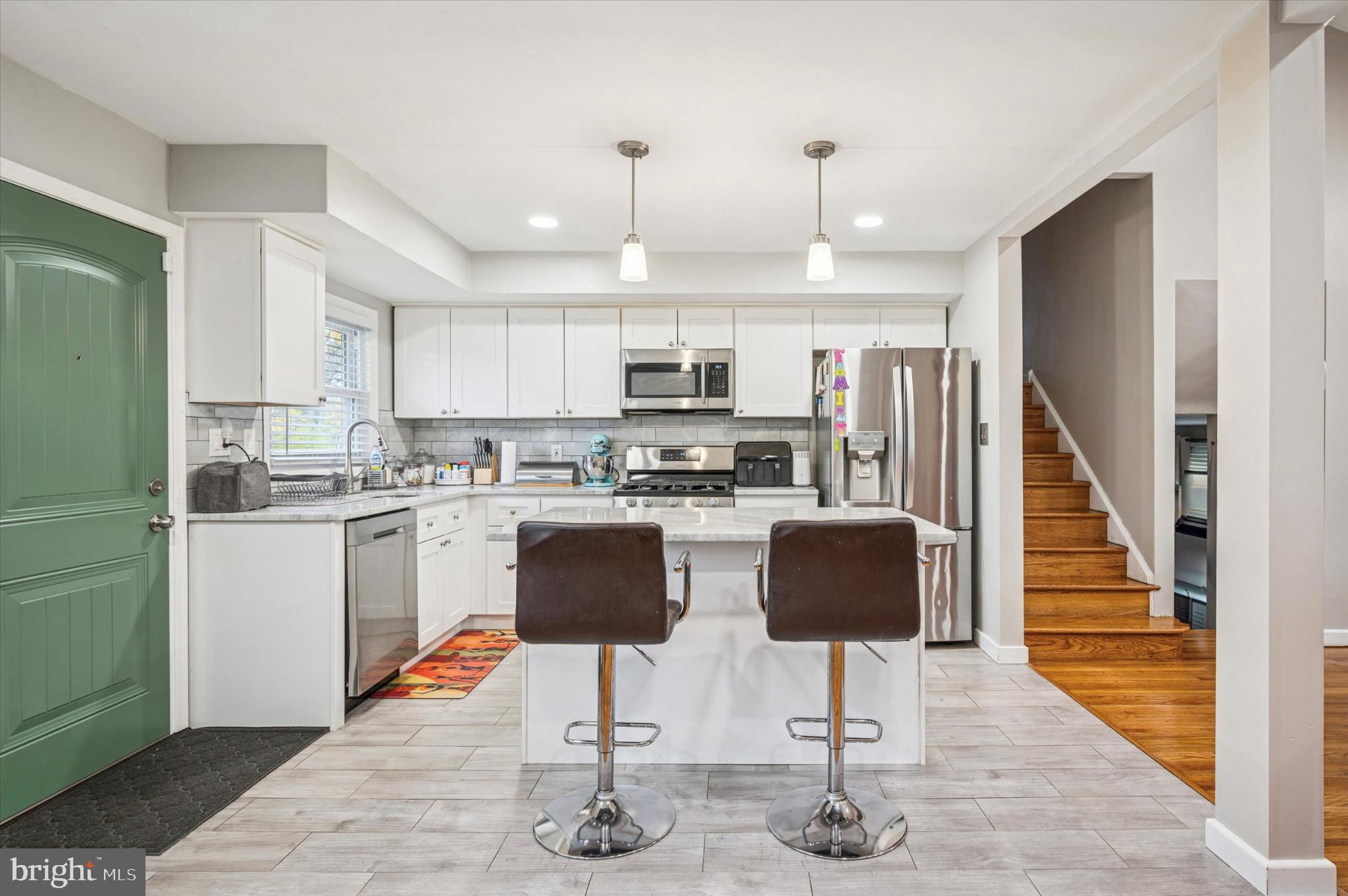 7410 Richards Road Elkins Park, PA 19027 - Photo 7 of 22 a kitchen with granite countertop kitchen island stainless steel appliances a stove a sink a refrigerator a stove and white cabinets