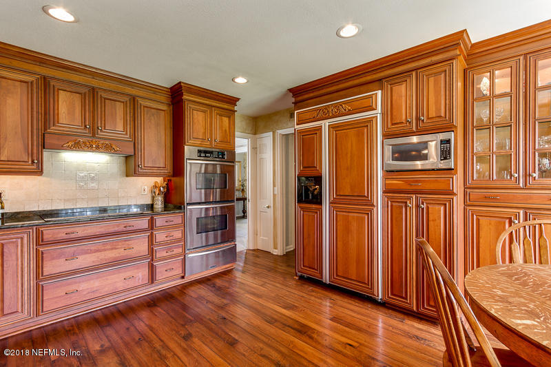 3679 Rustic Lane Jacksonville, FL 32217 - Photo 11 of 42 a kitchen with stainless steel appliances granite countertop a refrigerator and wooden cabinets