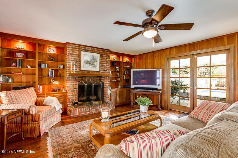 3679 Rustic Lane Jacksonville, FL 32217 - Photo 13 of 42 a living room with furniture a fireplace and a flat screen tv
