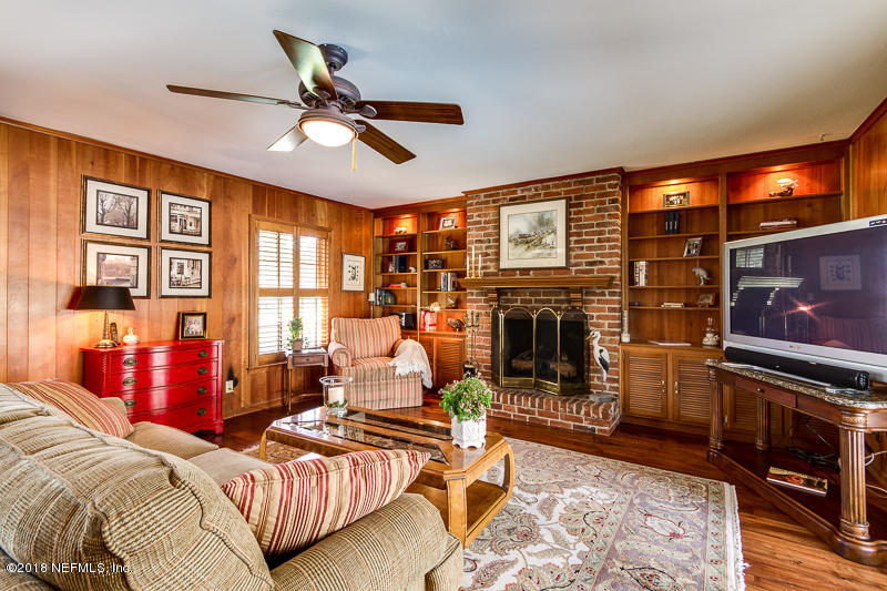 3679 Rustic Lane Jacksonville, FL 32217 - Photo 14 of 42 a living room with furniture a flat screen tv and a fireplace