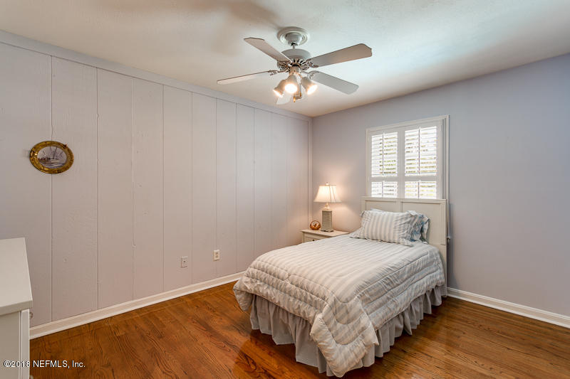 3679 Rustic Lane Jacksonville, FL 32217 - Photo 32 of 42 a bedroom with a bed and a chandelier