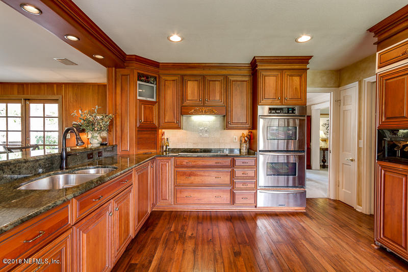 3679 Rustic Lane Jacksonville, FL 32217 - Photo 9 of 42 a kitchen with stainless steel appliances a refrigerator and wooden floor