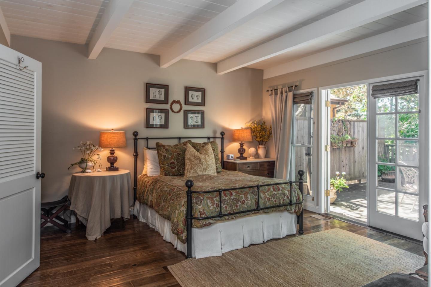 2- Carpenter & 3rd Street Carmel, CA 93921 - Photo 13 of 22 a bedroom with a bed and a mirror